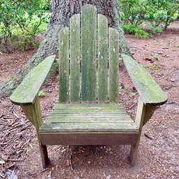 A Weathered Wooden Adirondack Chair- Front Yard