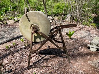 Antique Sharpening Stone Repurposed As An Outdoor Sculpture