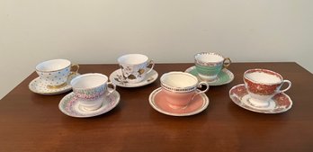 Group Of Five Tea Cups & Saucers With Various Designs