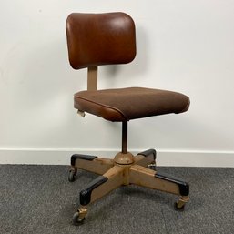 Brown Rolling Office Chair With Spring Loaded Back Rest