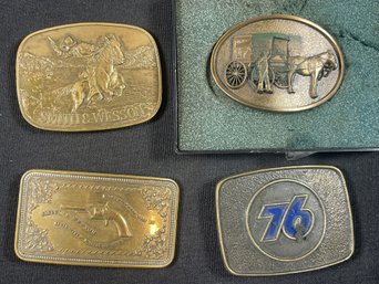 FOUR VINTAGE BELT BUCKLES INCLUDES TWO SMITH AND WESSON BELT BUCKLES