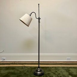 A Metal Floor Lamp With String Shade