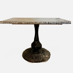 An Antique Iron Base Table With Granite Top