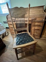 Oak Pressed Back Chair With Leather Tufted Seat, Double Stringers, And Spindle Back