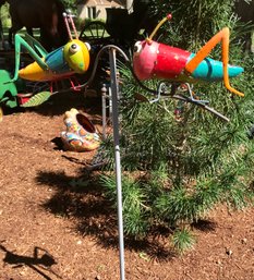 Pair Of Large Teetering Grasshoppers On Stand