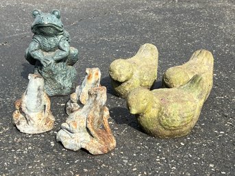 A Group Of Seven Little Outdoor Statues