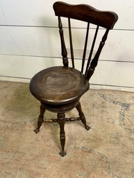 An Antique Spindle Back Swivel Piano Chair