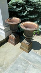 A Pair Of Vintage Cast Iron Planters On Base