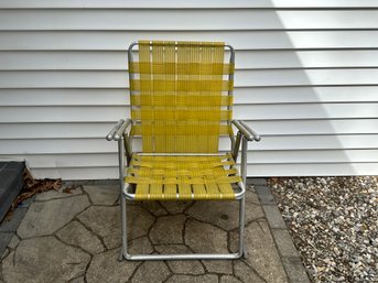 A Vintage Chair Webbed And Aluminum