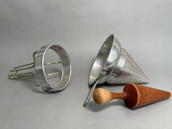 A Vintage Aluminum Sifter With Wooden Masher