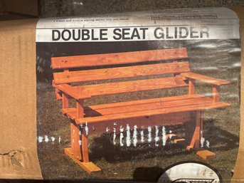 Double Seat Glider . New In Open Box . Assembly Required . Includes Hardware