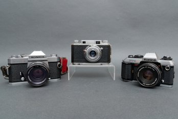 Three Vintage Konica Cameras With Lenses