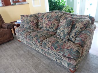 A Stylish And Inviting Couch Covered Soft, Fluffy Upholstery