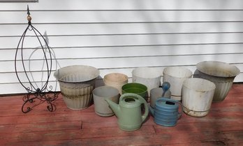 A Group Of Planters, Watering Cans & More