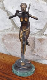 A Bronze Statue Of A Fairy Or Nymph Holding A Small Bowl Or Offering.