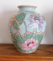 A Chinese Ceramic Vase Incised In Pastel Greens And Big Pink Water Lilly's
