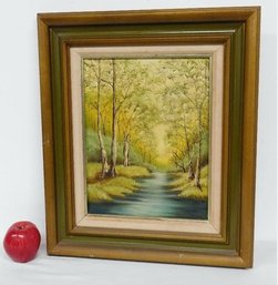 A Framed Painting Of A Stream Meandering Through The Trees