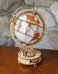 A 3 Dimensional Wooden Puzzle Globe With Thumb Wheel For Turning