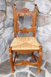 An Intricately Carved Rush Seat Chair