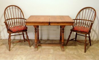 An English Oak Breakfast Table And Two Oak Windsor Chairs