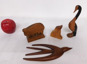 A Group Of Wooden Carvings Of Animals
