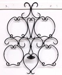 A Large Metal Hanging Plate Hangar With Candle For 4 Special Plates