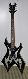 B.C. Rich Warlock Black Electric Guitar With White Tribal Decor.