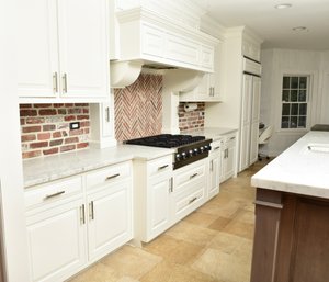 Custom Upper And Lower Wood Kitchen Cabinets With Carrera Marble Counter Top And Exhaust Fan