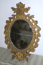 Antique Brass Hanging Mirrow With Lions Head And Leaf Decoration.