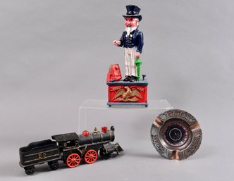 Uncle Sam Cast Iron Bank, Roulette Wheel Ashtray And Cast Iron Steam Locomotive Train