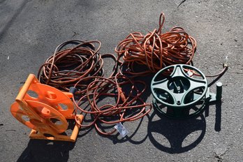 Lot Of Three Various Length Indoor/Outdoor Electric Cords & Two Cord Storage Reels