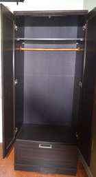 Black Coat Closet With Two Doors And A Deep Bottom Drawer