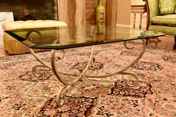 Beveled Edge Glass Cocktail Table With Scrolled Iron Base