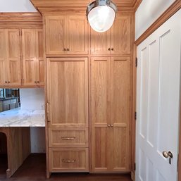 A Custom Oak Cabinetry Unit With Closet