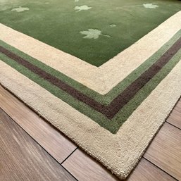 A Custom Wool Carpet With Stitched Maple Leaf Accents And Tan Border (12.5x15) - Basement