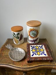 2 Canasters, Pewter Pineapple Dish, Ceramic And Wood Trivet