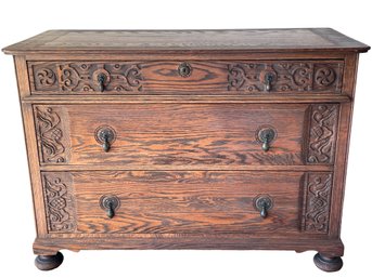 Vintage Carved Oak Dresser With Bun Feet And Bronze Hardware.