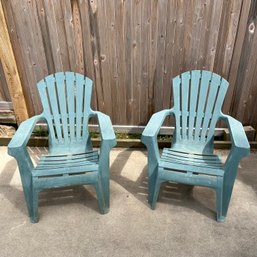 A Pair Of Green Molded Plastic Adirondack Chairs