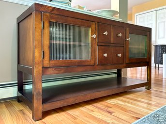A Modern Mahogany Console Cabinet With Glass Paneled Doors