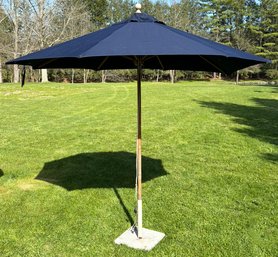 A Large Teak Patio Umbrella With Sunbrella Skin