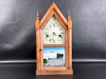 An Antique Steeple Mantel Clock With Reverse-Painted Glass Door