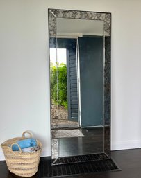 A Full Length Standing Mirror With Antiqued Glass Band