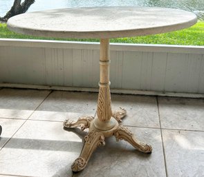 A Vintage Bistro Table With Cast Stone Top