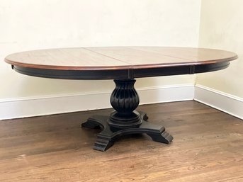 An Antique Mahogany Extendable Spindle Based Dining Table