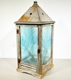 A Vintage Lantern With Pine Needle Motif On Glass