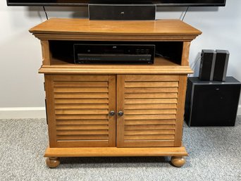 A Vintage Entertainment Cabinet With Louvered Doors