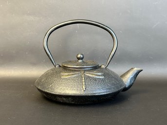A Beautiful Japanese-Style Cast-Iron Teapot With A Dragonfly Motif
