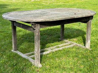 A Large Weathered Teak Extendable Dining Table By Gloster