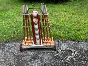 A Vintage Croquet Set With Metal Wheel Stand