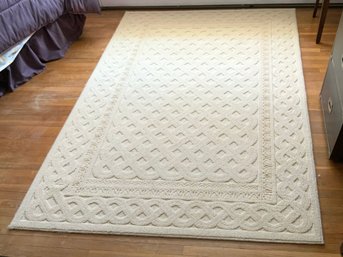 A Cream Colored Bound Area Rug